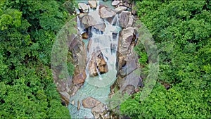 Flycam Removes from Foamy Rocky Mountain Waterfall Cascade