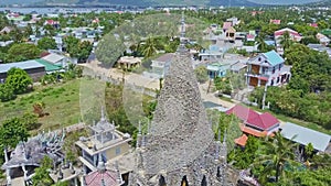 Flycam shows city hill and coral Buddhist temple tower