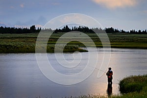 Flyfisherman on River with Tetons in Background