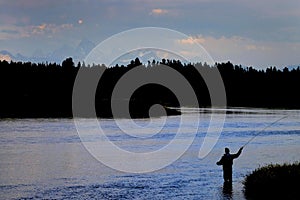 Flyfisherman on River with Tetons in Background