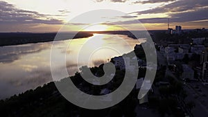 Flying above the city and a temple with golden dome located by the river. Clip. The beauty of small summer town in the