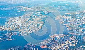 Flying above the clouds and the landscape airport over Singapore