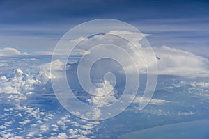 Flying above the earth and above the clouds in the territory of Singapore. Airplane window view. The plane flies in sky above the