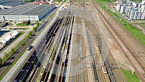 Flying above industrial railroad station with cargo trains and freight containers. Railroads and shipping container trains