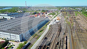 Flying above industrial railroad station with cargo trains and freight containers. Railroads and shipping container trains