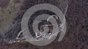 Flying above medieval fortress ruins, aerial view of a stronghold. Liteni, castle, Transylvania, Romania