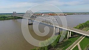 Flying Above the Mississippi River and Veterans Memorial Bridge in New Orleans. Gramercy Alumina Refinery Factory in Background