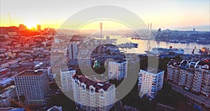 Flying above Vladivostok city center and residential area at sunrise. Russia