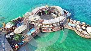 Flying above young people clubbing on zrce beach, Pag island