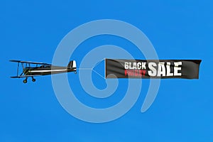 Flying airplane and Black Friday sale banner on blue sky.