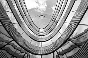 Flying airplane and modern architecture building photo