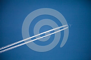 Flying airplane with two condensation trails