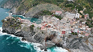 Flying around of Vernazza, famous Cinque Terre town. Summer daylight drone shot