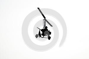 Flying autogyro silhouette on white background