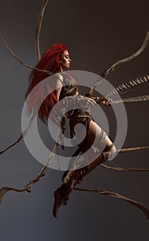 Flying beautiful red haired woman bounding by ropes photo