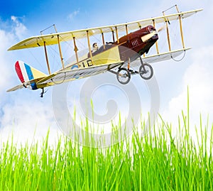 Flying biplane over a airfield.