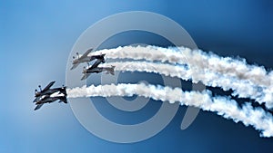 Four piston propeller aerobatic aicraft during display.