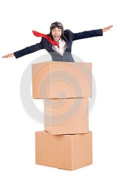 Flying businessman in cardboard boxes