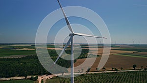 Flying closely to a spinning wind turbine near agricultural fields