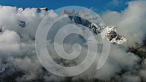 Flying through clouds between mountains