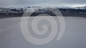 Flying among the clouds with a view of mountains