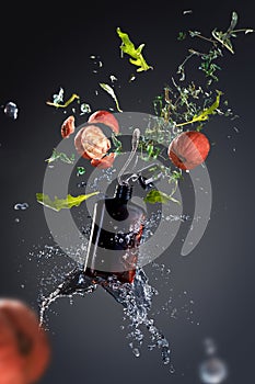 Flying cosmetic product with splashes and elements of nuts, herbs and leaves on a gray background.  Poster product photography