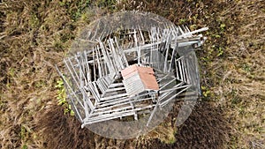 Flying counterclockwise over a destroyed building with a rotten roof.