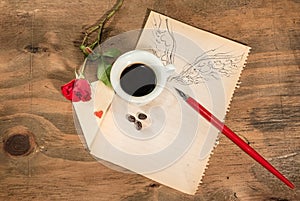 Flying cup of coffee with red rose and playing card.