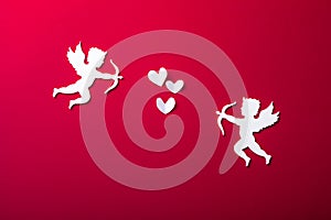 Flying cupid silhouette,  happy Valentine`s Day banners, paper art style. Amour on red paper