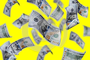 Flying dollars banknotes isolated On a yellow background. Money is flying in the air. 100 US banknotes new sample.