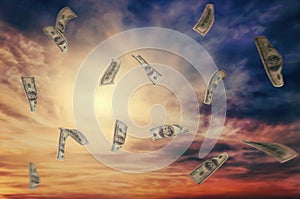 Flying dollars on sky background