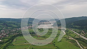 Flying drone above populated valley