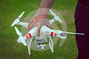 flying drone with camera in hand