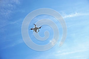 Flying drone in the clear blue sky.