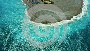 Flying on a drone over a beautiful beach with turquoise water and shoreline with hotels of Rhodes Greece Europe. Ellie