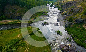 Flying on drone over an evening picturesque valley with stormy streams and rapids of Iset river, tourist places to travel. Ural,