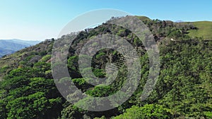 Flying a drone over a hill. Rainforest. Aerial Photography
