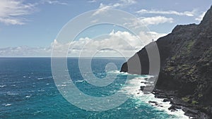 Flying drone over the ocean. View of makapuu lighthouse. Waves of Pacific Ocean wash Rocky shore. Magnificent mountains