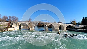 Flying drone over the old Seljuk bridge over the Eurymedon River in Antalya province, Turkey. 4k, slow motion.