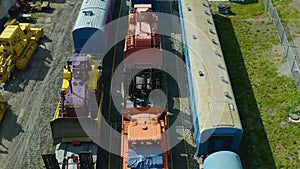 Flying on drone over railway depot, a top view of locomotives and trains for servicing railway tracks at a marshalling