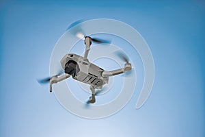 Flying Drone Underside with Teal Blue Sky photo