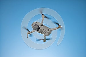 Flying Drone Underside with Teal Blue Sky photo