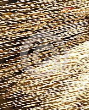 Flying fire sparks on a black background. Abstract steel wool sparkles or embers effect to use as a background for the