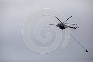 Flying firefighter helicopter with a water tank