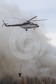 Flying firefighter helicopter with a water tank