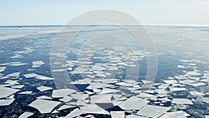 Flying forward over Baltic sea with floating ice floes, Holmsund locality, close to Umea city, Vasterbotten county, Sunny spring