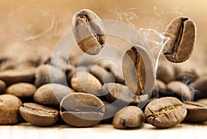 Flying fresh coffee beans as a background with copy space. Coffee beans falling down with white steam vapour.