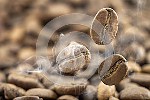 Flying fresh coffee beans as a background with copy space. Coffee beans falling down with white steam vapour.