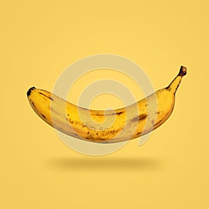 Flying banana isolated on yellow background