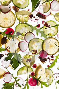 Flying fruits and vegetables on bright white